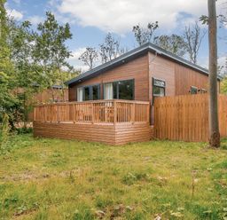 A house with a wooden deck and fenced area at Stamford Spa (Pet) Louth