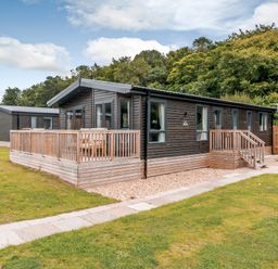 A lodge with decking and steps at Elsham Lodge (Pet) Louth