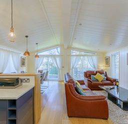 A living room with a sofa and dining area at Retreat Lodge 4 in Louth