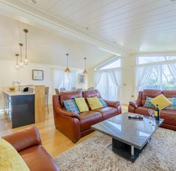 A living room with a sofa and coffee table at Retreat Lodge 4 in Louth