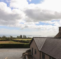 A view of the sea and fields from a cottage at Bryn Mor Cottage in Mynytho near Llanbedrog