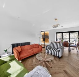 A living room with sofas and a dining table at Heddfan in Carmarthen