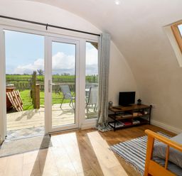 A living room with a view of the outdoors at Grape Escape near Halesworth