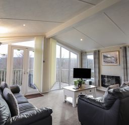 A living room with a sofa and television at Monach 1