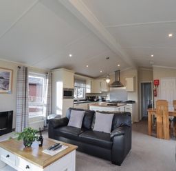 A living room with a sofa and fireplace at Monach 1