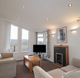 A living room with a television and fireplace at Colonsay