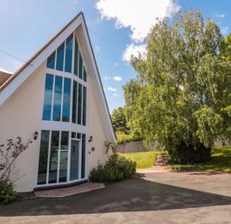 A house with large windows and a pathway leading up at Lady Of Lourdes Whitchurch, Herefordshire