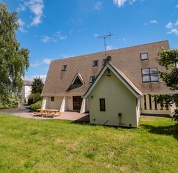 A house with a patio and benches at Lady Of Lourdes in Whitchurch, Herefordshire