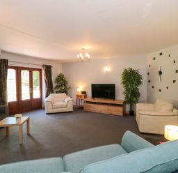 A living room with a sofa and television at Lady Of Lourdes Whitchurch, Herefordshire