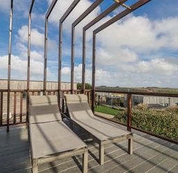 A deck with sun loungers and a view at Adelaide in Redruth