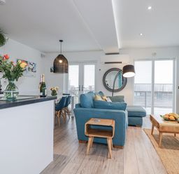 A living room with a sofa and coffee table at Adelaide in Portreath