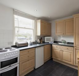 A kitchen with an oven and sink at Snugglers Cove in Dartmouth
