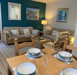 A living room with seating and a dining area at Snugglers Cove in Dartmouth