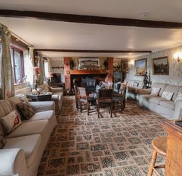 A living room with a sofa and dining table at Winston Lodge in Beccles