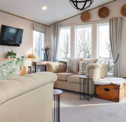 A living room with a television and windows at FW4 (Fairways 4)