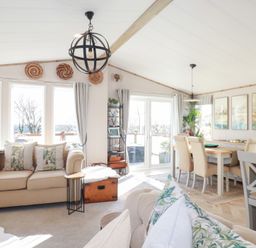A living room with a sofa and dining table at FW4 (Fairways 4)
