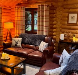 A living room with a sofa and coffee table at Little Bears Hideaway @ 23 Lakeside Felmoor Park near Felton
