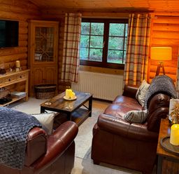 A living room with a sofa and coffee table at Little Bears Hideaway @ 23 Lakeside Felmoor Park near Felton