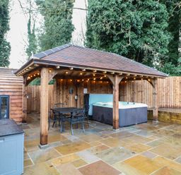 An outdoor area with a hot tub and seating at Park View Lodge