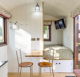 A bedroom with a bed and table at No 1 The Orchard Upton Warren