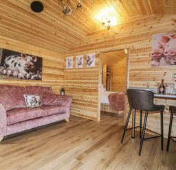 A snug with a sofa and bar stools at The Sty in Hatton, Derbyshire
