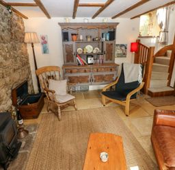 A living room with a rocking chair and a coffee table at 1 Mill Farm Cottages Narberth