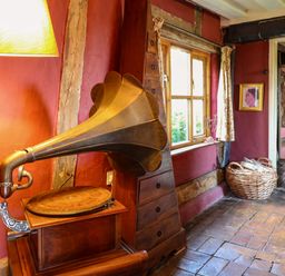 A living room with a gramophone and window at Town Farm