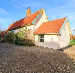 A house with a gravel driveway and trees at Town Farm in 