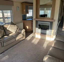 A living room with sofas and a fireplace at Gainc Bach in Abergele
