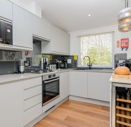 A kitchen with cabinets and appliances at The Elton in Kings Cliffe