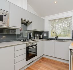 A kitchen with appliances including a microwave and oven at The Castor in Kings Cliffe