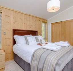 A bedroom with a bed and bedside table at The Chesterton in Kings Cliffe