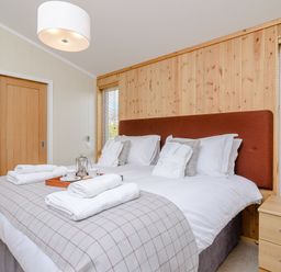 A bedroom with a bed and a bedside table at The Chesterton in Kings Cliffe