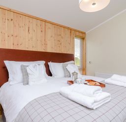 A bedroom with a bed, towels, coffee tray at The Chesterton in Kings Cliffe