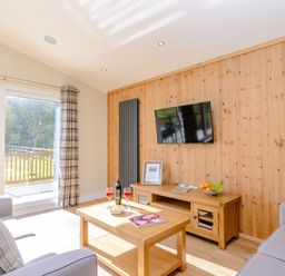 A living room with a television and coffee table at The Chesterton (Pet) in Kings Cliffe