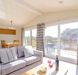 A living room with a sofa and dining table at The Chesterton (Pet) in Kings Cliffe