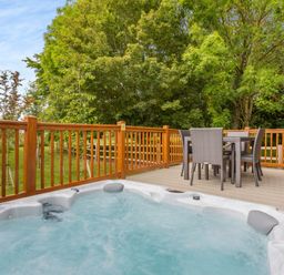 An outdoor area with a hot tub and seating at The Nassington (Pet) in Kings Cliffe