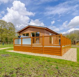 A house with a deck and grass area at The Yarwell in Kings Cliffe