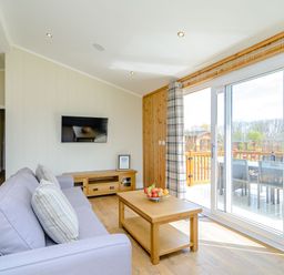A living room with a sofa and television at The Yarwell in Kings Cliffe