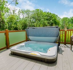 A hot tub on a deck with seating at The Wansford in Kings Cliffe
