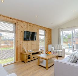 A living room with a television and fruit bowl at The Ailsworth (Pet) in Kings Cliffe
