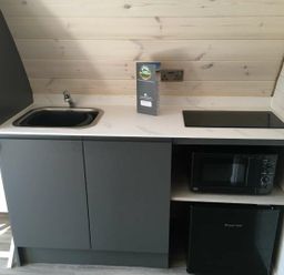 A kitchen with a sink, electric stove, microwave, and refrigerator at Pod 1 (Pet Friendly) in Carnforth