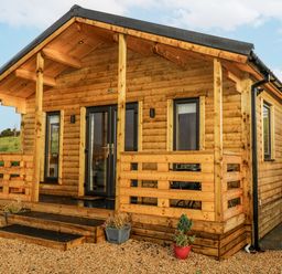 A log cabin with steps and porch at Glenview Log Cabin in Ballycastle