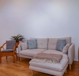 A living room with a sofa and a chair at The Maisonette in Hayle