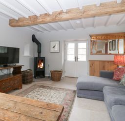 A living room with a television and a sofa at Velindra Farm Cottage in Hereford