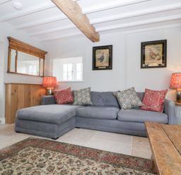 A living room with a sofa and coffee table at Velindra Farm Cottage Hereford