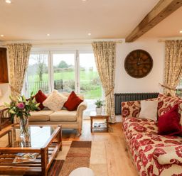 A living room with a sofa and a coffee table at Lake View in Crediton