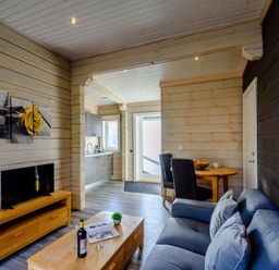 A living room with a television and a dining table at Chestnut Spa Carlton Miniott near Thirsk