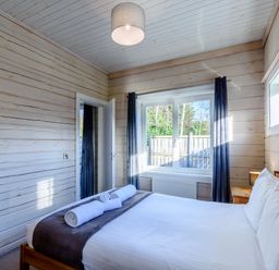 A bedroom with a bed and towels at Chestnut Spa in Carlton Miniott near Thirsk