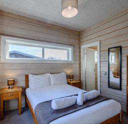 A bedroom with a bed and furniture at Chestnut Spa Carlton Miniott near Thirsk